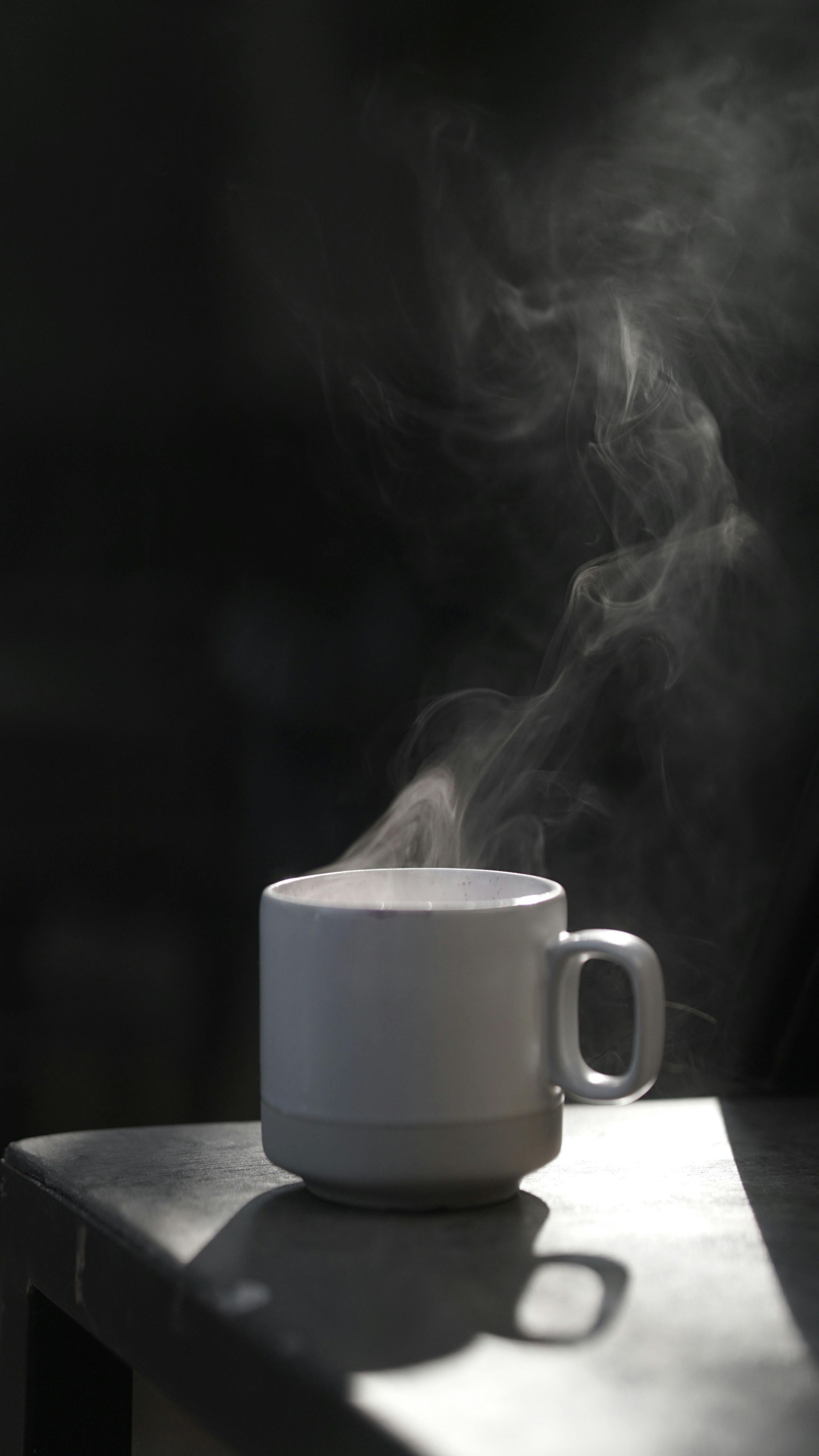 Matcha bowl with rising steam on a wooden table